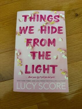 Things We Hide From The Light by Lucy Score - Pink Paperback